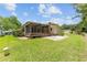 Home's backyard, patio area, and landscaping at 1303 E Schwartz Blvd, Lady Lake, FL 32159