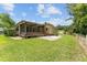 Home's backyard, patio area, and landscaping at 1303 E Schwartz Blvd, Lady Lake, FL 32159