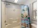 Bright bathroom featuring an updated shower and a tropical themed shower curtain at 1303 E Schwartz Blvd, Lady Lake, FL 32159
