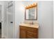 Bathroom vanity with mirror, lighting, storage, and modern fixtures at 1303 E Schwartz Blvd, Lady Lake, FL 32159