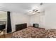 Bright bedroom featuring wood-look floors, ceiling fan, closet and a window with black curtains at 1303 E Schwartz Blvd, Lady Lake, FL 32159