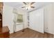 Bright bedroom featuring wood-look floors, built-in closet and a window with light colored curtains at 1303 E Schwartz Blvd, Lady Lake, FL 32159