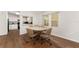 Dining area with wood floors and natural light from kitchen and backyard windows at 1303 E Schwartz Blvd, Lady Lake, FL 32159