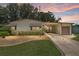 Charming single-story home with a manicured lawn and a covered parking area at 1303 E Schwartz Blvd, Lady Lake, FL 32159