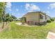 A charming home featuring a spacious backyard with well-maintained landscaping and mature trees at 1303 E Schwartz Blvd, Lady Lake, FL 32159