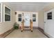 Welcoming covered front porch featuring decorative lighting and a secure entry door at 1303 E Schwartz Blvd, Lady Lake, FL 32159