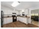 Practical kitchen with white cabinetry and black appliances at 1303 E Schwartz Blvd, Lady Lake, FL 32159