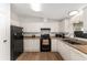 Functional kitchen with black appliances and sleek countertops at 1303 E Schwartz Blvd, Lady Lake, FL 32159
