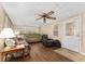 Comfortable living room with multiple windows and a ceiling fan at 1303 E Schwartz Blvd, Lady Lake, FL 32159