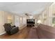 Relaxing living room with laminate flooring, fan, and television at 1303 E Schwartz Blvd, Lady Lake, FL 32159