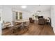 Open-concept living room with wood floors, ceiling fan, and dining area at 1303 E Schwartz Blvd, Lady Lake, FL 32159