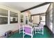 A screened porch with a table and four chairs overlooking a peaceful backyard at 1303 E Schwartz Blvd, Lady Lake, FL 32159