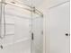 Modern glass shower featuring sleek chrome fixtures and a built-in shelving unit at 1303 E Schwartz Blvd, Lady Lake, FL 32159