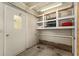 Functional storage area with built-in shelving and a door, maximizing space and organization at 1303 E Schwartz Blvd, Lady Lake, FL 32159
