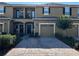 Inviting townhouse featuring a private balcony, one-car garage, and a charming brick paver driveway at 147 Aston Grande Dr, Daytona Beach, FL 32124