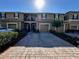 Townhouse exterior with a one-car garage, brick paver driveway, and a private balcony at 147 Aston Grande Dr, Daytona Beach, FL 32124