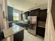 Modern kitchen featuring granite countertops, stainless steel appliances, and dark cabinetry at 147 Aston Grande Dr, Daytona Beach, FL 32124