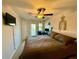 Well-lit main bedroom featuring a ceiling fan, access to balcony, and comfortable carpet at 147 Aston Grande Dr, Daytona Beach, FL 32124