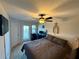 Inviting main bedroom with a ceiling fan, balcony access, and neutral carpet at 147 Aston Grande Dr, Daytona Beach, FL 32124