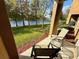 Covered patio with outdoor furniture overlooking manicured lawn and serene water feature at 147 Aston Grande Dr, Daytona Beach, FL 32124