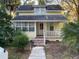 Charming two-story home with a covered front porch and lush landscaping, offering curb appeal at 148 W 9Th Ave, Mount Dora, FL 32757