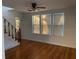 Bright living room with hardwood floors and large windows, creating a warm and inviting atmosphere at 148 W 9Th Ave, Mount Dora, FL 32757