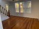 A bright living room featuring hardwood floors and large windows, offering natural light and charm at 148 W 9Th Ave, Mount Dora, FL 32757
