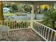 A cozy covered porch with brick flooring and a view of the street, perfect for relaxing at 148 W 9Th Ave, Mount Dora, FL 32757
