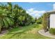 Lush green backyard features verdant landscaping and mature trees offering serene privacy at 1521 Southport St, The Villages, FL 32162