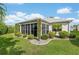 Exterior of home with screened-in windows and mature landscaping for privacy at 1521 Southport St, The Villages, FL 32162