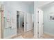 Hallway leading to a walk-in closet inside the bathroom, with star-shaped decor on the wall at 1521 Southport St, The Villages, FL 32162