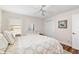 Comfortable bedroom with ceiling fan, wood floors, and warm, inviting decor at 1521 Southport St, The Villages, FL 32162