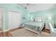Well-lit bedroom with wood floors, ceiling fan, and soft, serene color scheme at 1521 Southport St, The Villages, FL 32162