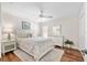 Comfortable bedroom with ceiling fan, wood floors, and warm, inviting decor at 1521 Southport St, The Villages, FL 32162