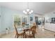 Light-filled dining area with seating for four and a view to the living room at 1521 Southport St, The Villages, FL 32162