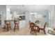 Bright dining area features tile floors, seating for four, and a view into the kitchen at 1521 Southport St, The Villages, FL 32162