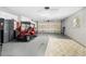 Spacious garage with golf cart, tool storage, and ample room for parking at 1521 Southport St, The Villages, FL 32162