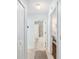 Hallway with views to the bathroom and bedroom, and tile floors at 1521 Southport St, The Villages, FL 32162