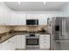 Updated kitchen features stainless steel appliances and granite countertops at 1521 Southport St, The Villages, FL 32162