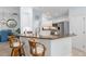 Kitchen bar with seating opens to the updated kitchen with stainless steel appliances at 1521 Southport St, The Villages, FL 32162