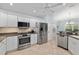 Bright kitchen with stainless steel appliances and tile floors at 1521 Southport St, The Villages, FL 32162