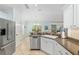 Bright kitchen boasts stainless steel appliances, granite countertops, and tile flooring at 1521 Southport St, The Villages, FL 32162