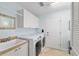 Laundry room with sink, cabinets, and washer and dryer at 1521 Southport St, The Villages, FL 32162