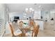 Open-concept living space with dining area, kitchen bar, and living room at 1521 Southport St, The Villages, FL 32162