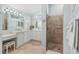 Main bathroom featuring dual sinks, a walk-in shower, and tile flooring at 1521 Southport St, The Villages, FL 32162