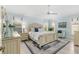 Light-filled main bedroom features plantation shutters, a ceiling fan, and stylish furnishings at 1521 Southport St, The Villages, FL 32162