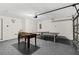 Spacious basement with a ping pong table, foosball, and finished floors; great recreational space at 157 Julliard Blvd, Davenport, FL 33897