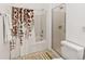 Bathroom featuring a shower-tub combo with a leaf-themed curtain and a separate glass-enclosed shower at 157 Julliard Blvd, Davenport, FL 33897
