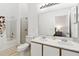 Well-lit bathroom with double sinks, a shower-tub combo, and a large mirror with great lighting at 157 Julliard Blvd, Davenport, FL 33897