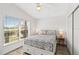 Bright bedroom with a queen-size bed, neutral decor, a large window, and built in storage on either side at 157 Julliard Blvd, Davenport, FL 33897